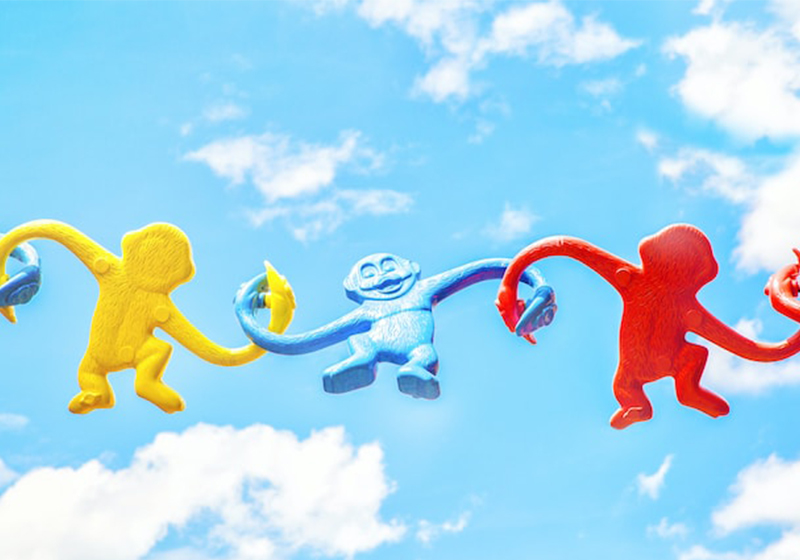 toy story land in disney world, colorful monkey toys hanging in the sky