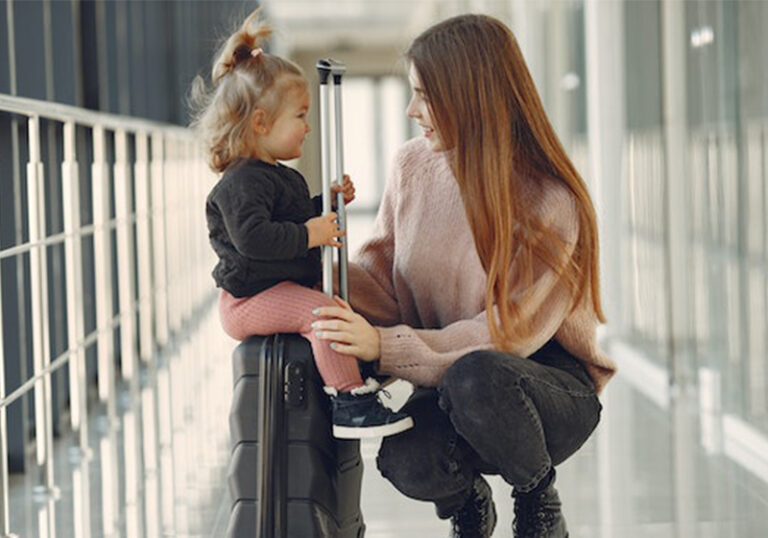 a mother and daughter in an airport holding