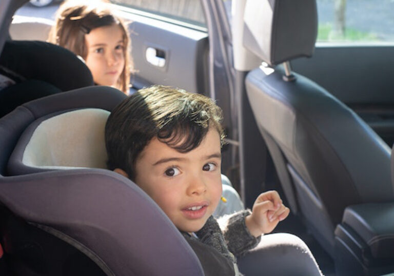 toddler in car seat on a road trip