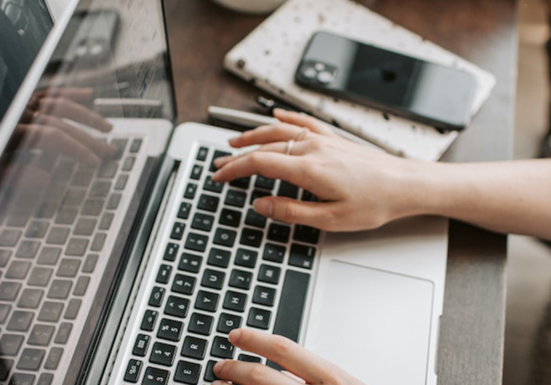 girl typing on laptop 